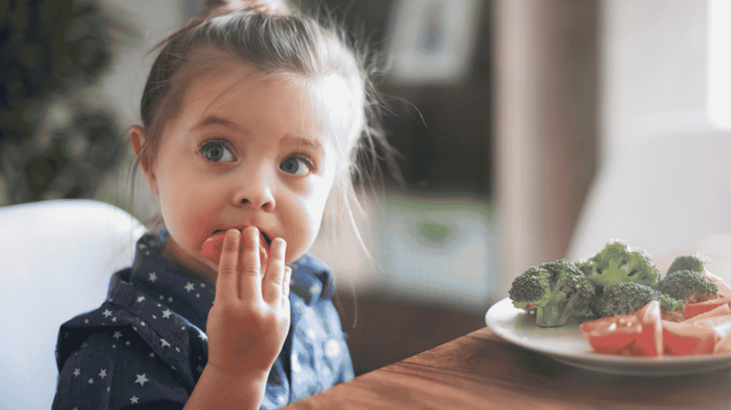 a-little-girl-eating-vegetables