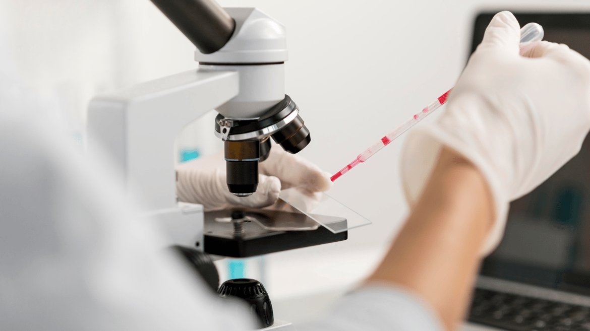 researcher using microscope