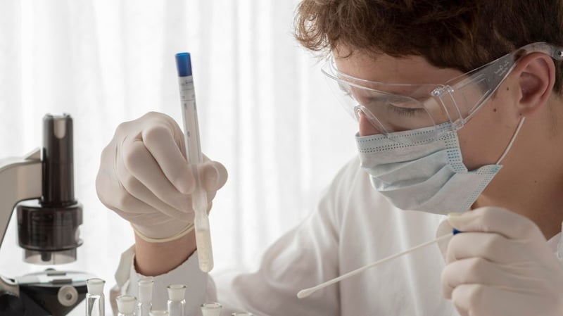 A guy holding the test tube