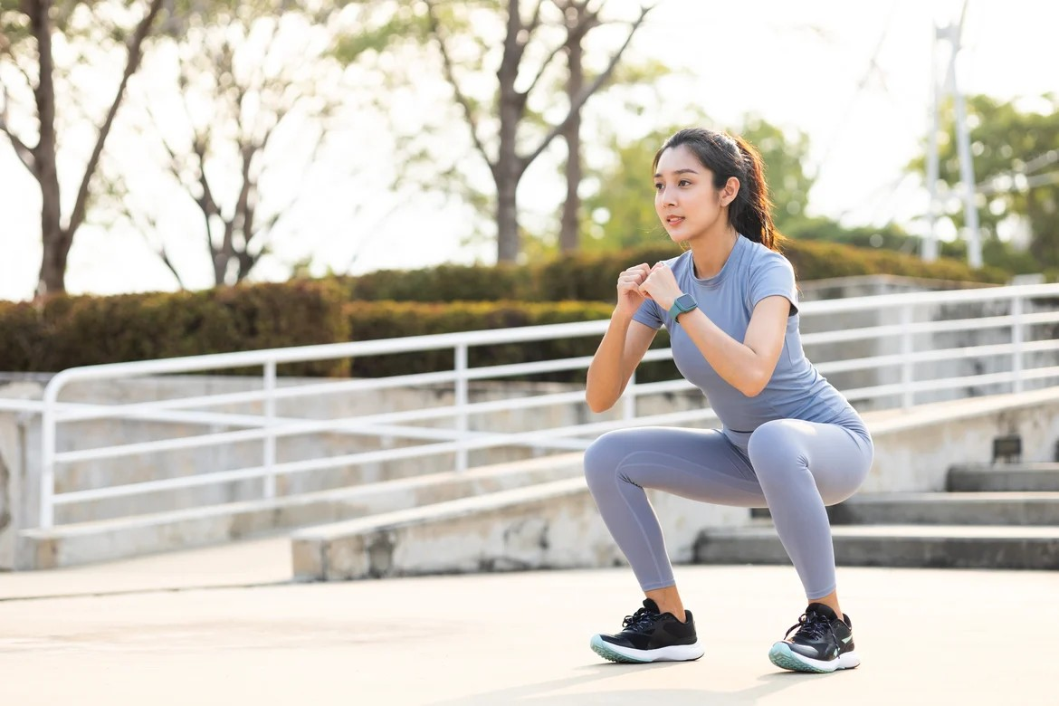women doing squat outdoors