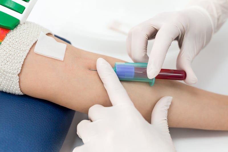 A professional taking a blood sample from a patient 