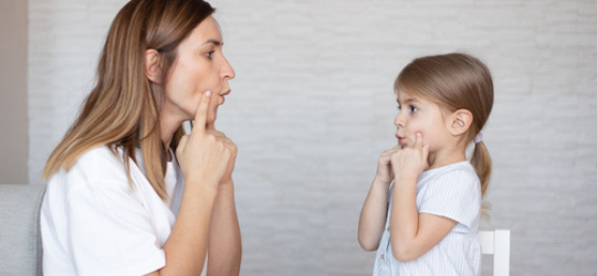 Cute little girl with speech therapist