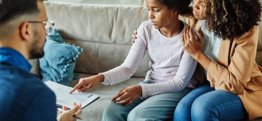 Mother with her teenage daughter discussing mental health