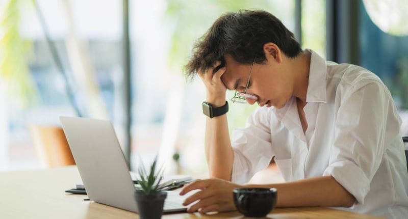 A young man gets confused during working