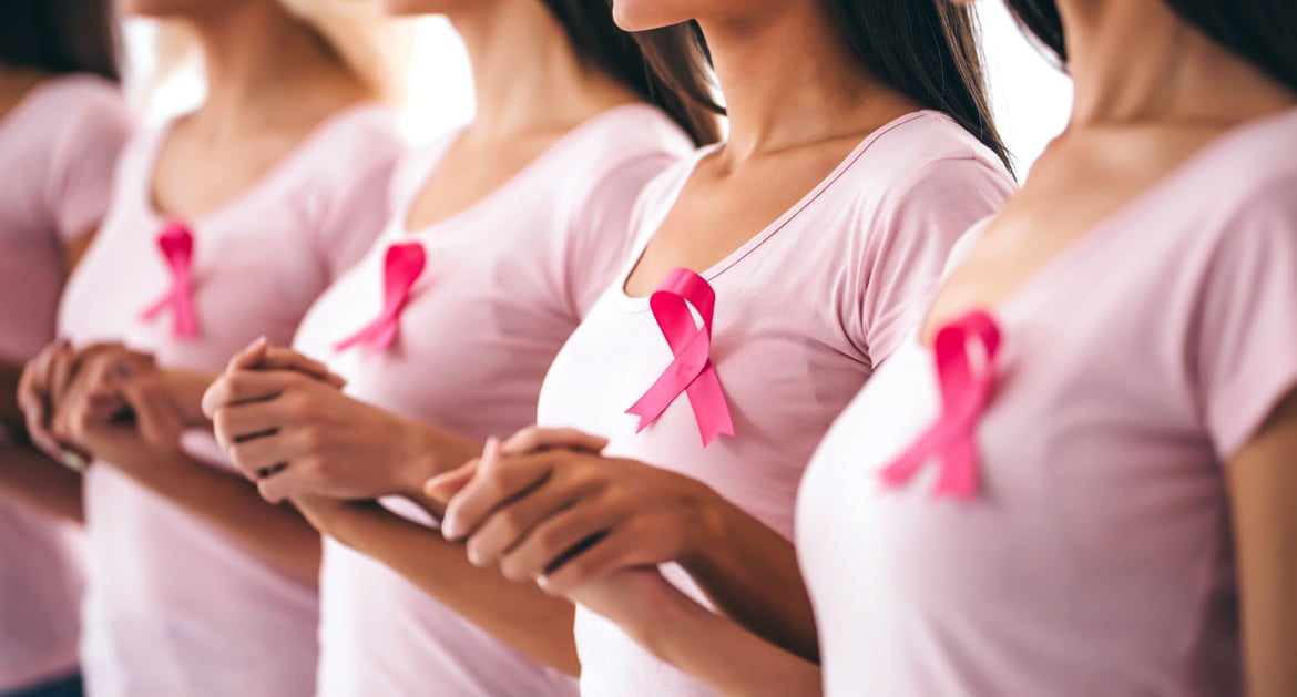 Woman holding hands in solidarity for breast cancer awareness day