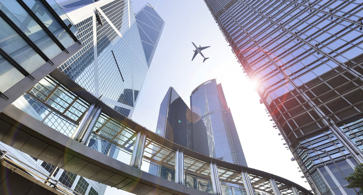 airplane-passing-by-city-landscape
