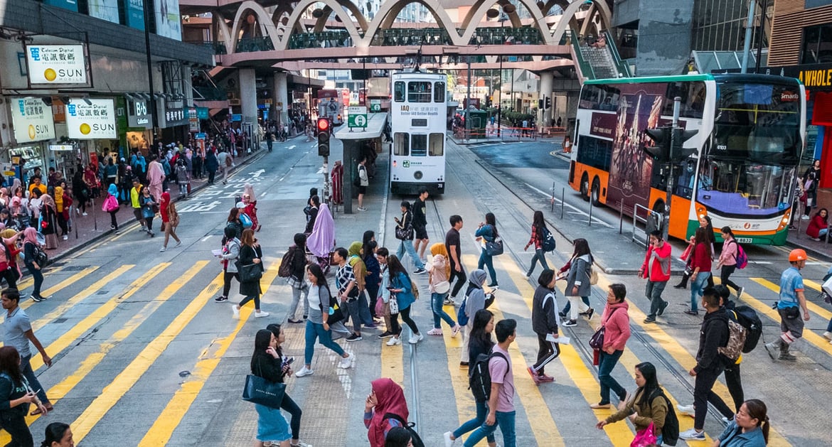 hong kong people crossing tram