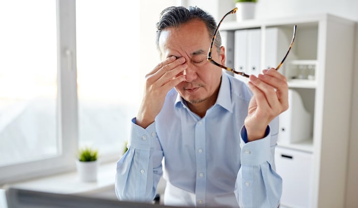 Stressed and burnout man in office desk