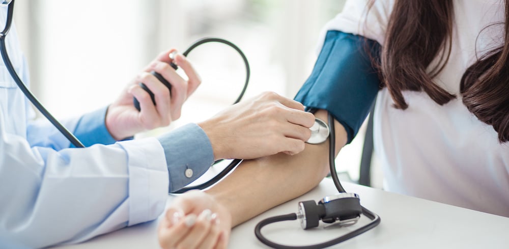 Doctor taking blood pressure