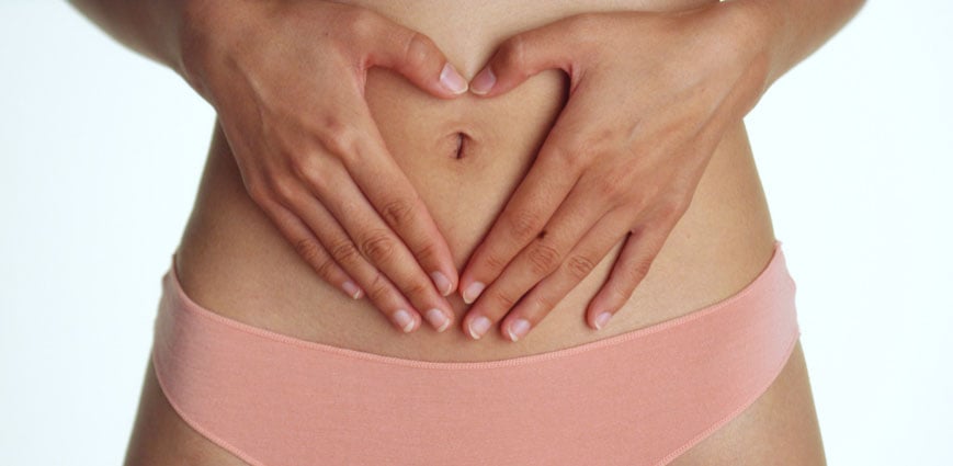 Early pregnant woman touching her stomach