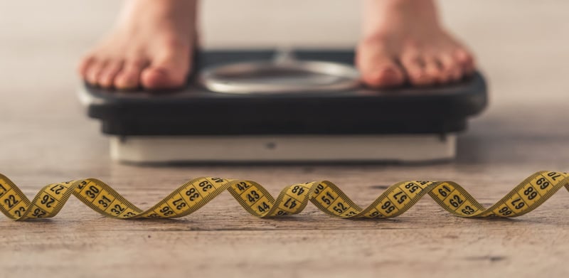 Male weighing on scale