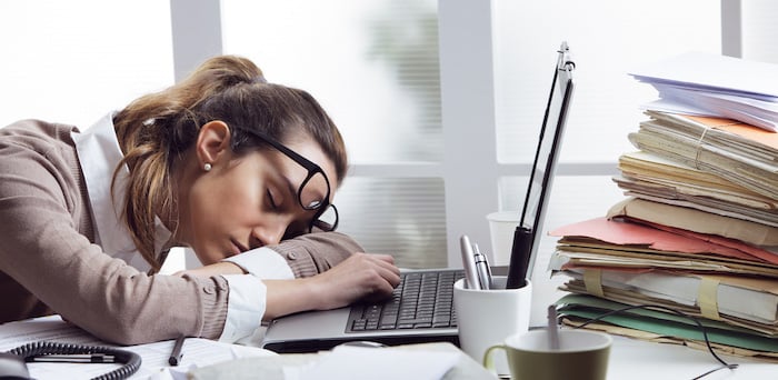 lady tired at desk