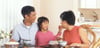 happy child with parents at dining table