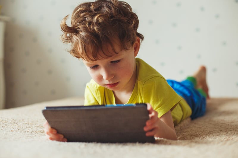 little boy using ipad