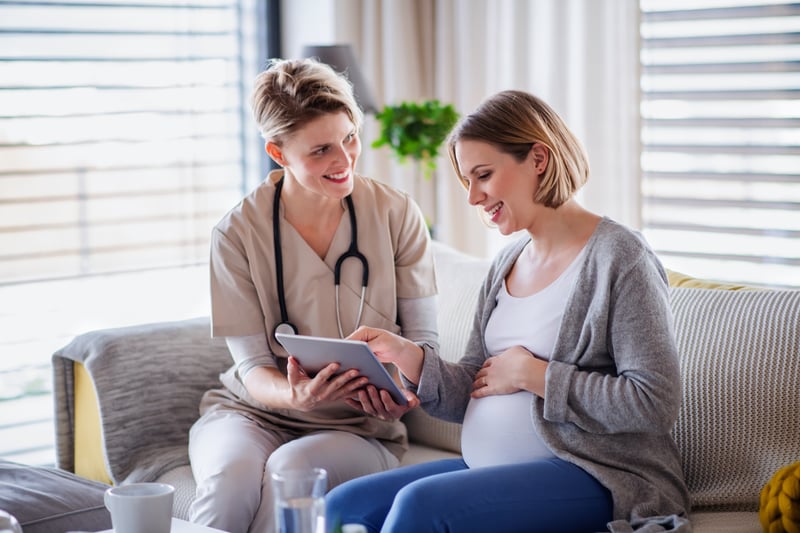 Midwife pointing at ipad to patient