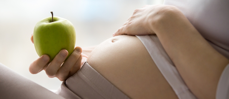 pregnant woman with apple