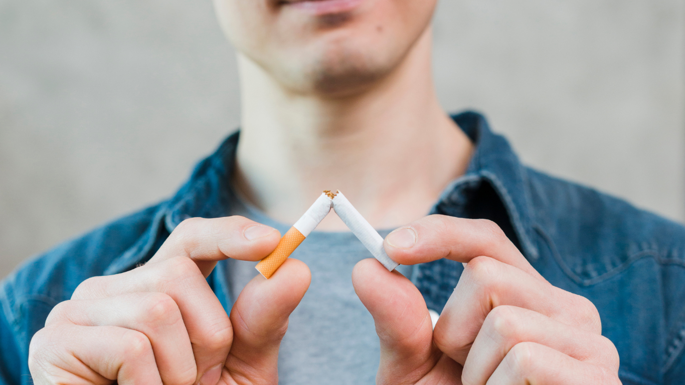 Person breaking a cigarette, quitting smoking