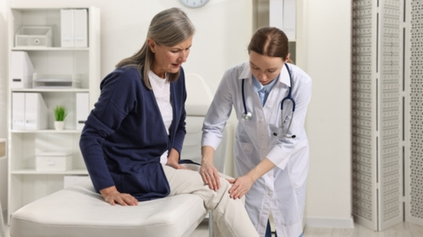 Doctor checking patient's knee