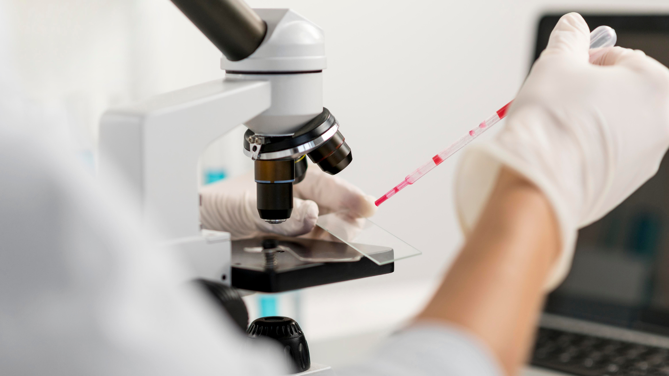 researcher using microscope