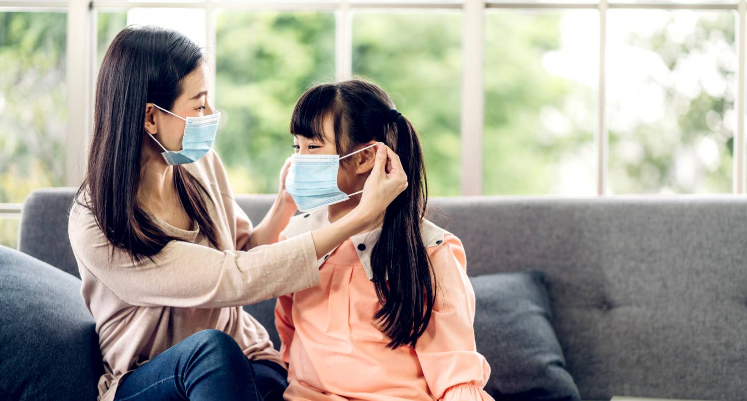 母親為女兒戴上口罩