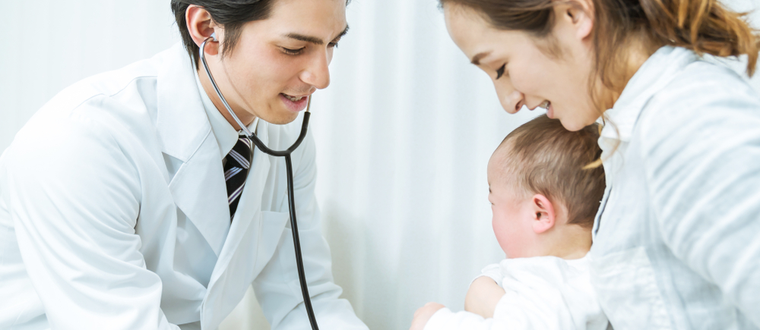 A doctor conducting a standard medical checkup on a baby.