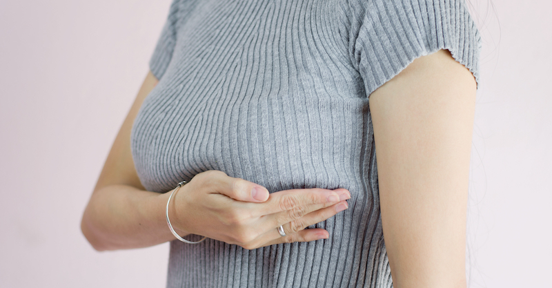 patient feeling breast for lump