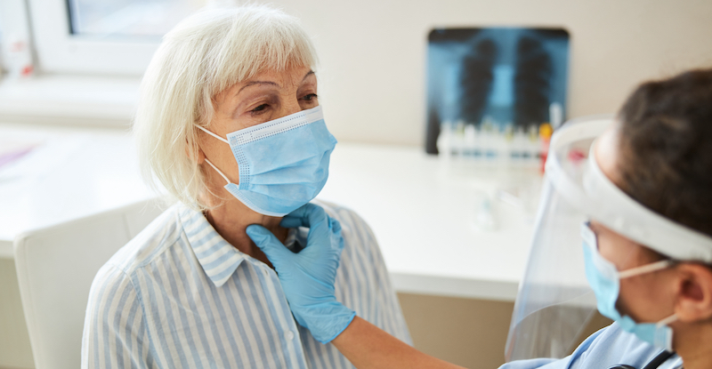 doctor checking patients throat