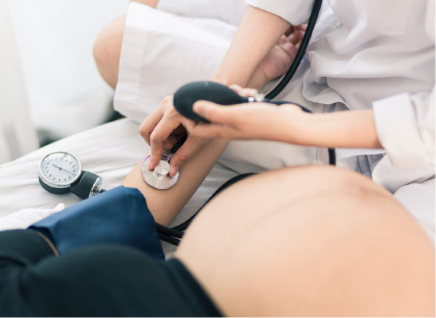 Obstetrician monitoring pregnant mothers heart