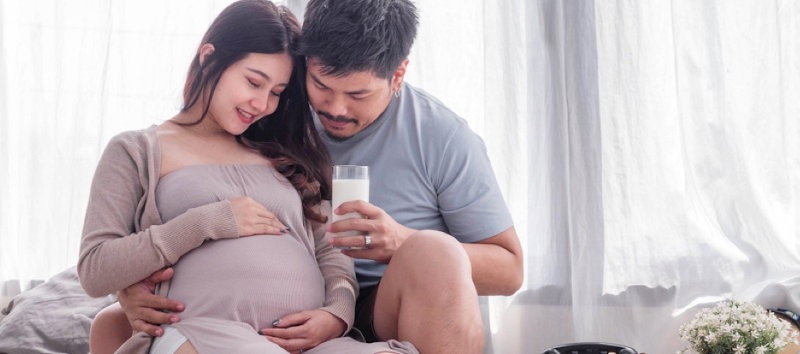 Young pregnant couple at home