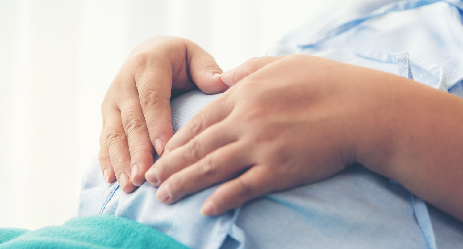 A woman touching her belly