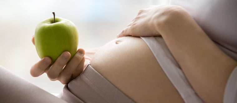 pregnant woman with apple